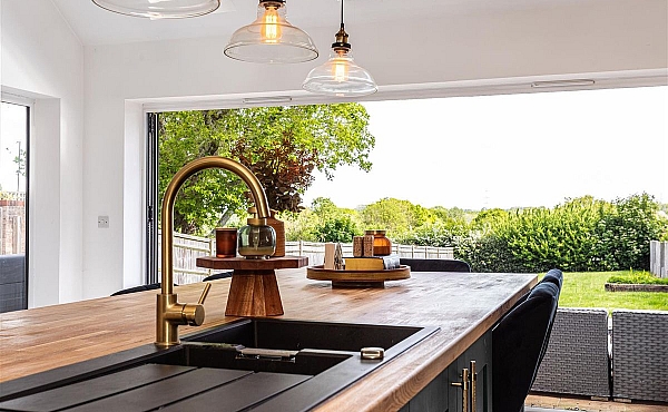 Room: Kitchen | A well-maintained kitchen featuring cabinetry, a countertop with a sink, and a window providing natural light.