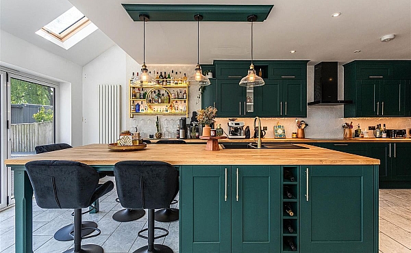 Room: Kitchen | A well-maintained kitchen featuring cabinetry, a countertop with a sink, and a chair.