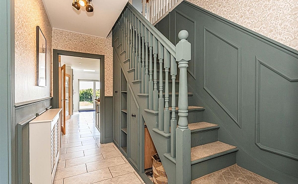Room: Ground Floor Hallway | An indoor staircase with a handrail and balusters, featuring detailed molding and flooring, within a well-maintained property.