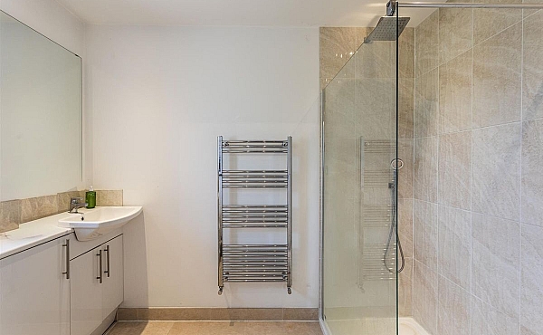 Room: Bathroom 2 | A clean, well-maintained bathroom featuring a bathtub, sink with tap, tiled walls and floor, and various bathroom accessories.