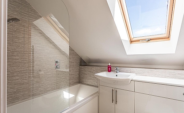 Room: Bathroom 3 | A clean and well-maintained bathroom featuring a sink, window, and tiled interior.