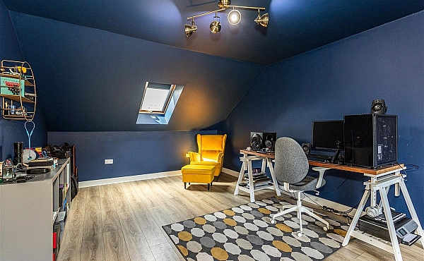 Room: Bedroom 3 | A well-furnished indoor room featuring a television, multiple chairs, a desk, and a ceiling fan.