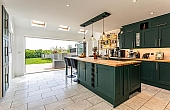 Room: Kitchen | A well-maintained kitchen featuring cabinetry, a countertop, sink, and a chair, with tiled flooring and a ceiling light.