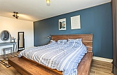 Room: Bedroom 2 | A well-presented bedroom featuring a neatly made bed with bedding, pillows, and a nightstand.